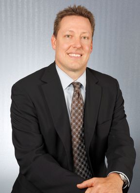 Gerard Kaiser in a suit and brown tie